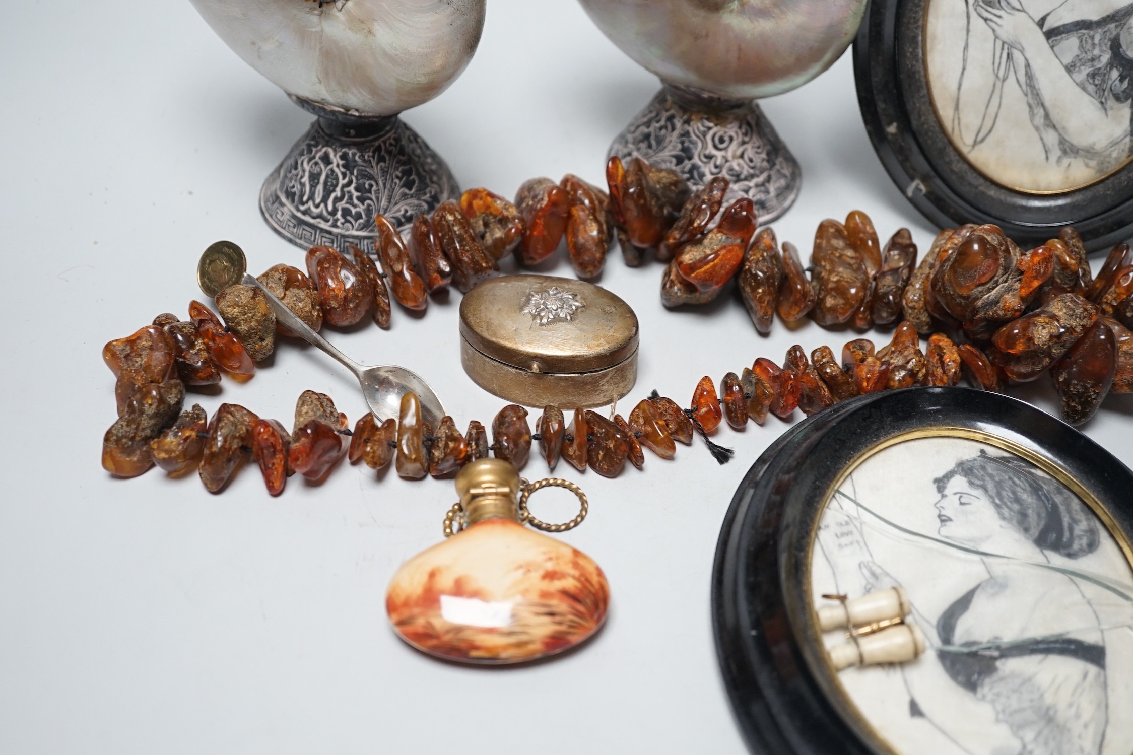 A pair of mother of pearl and silvered swan ornaments, amber and mixed collectables